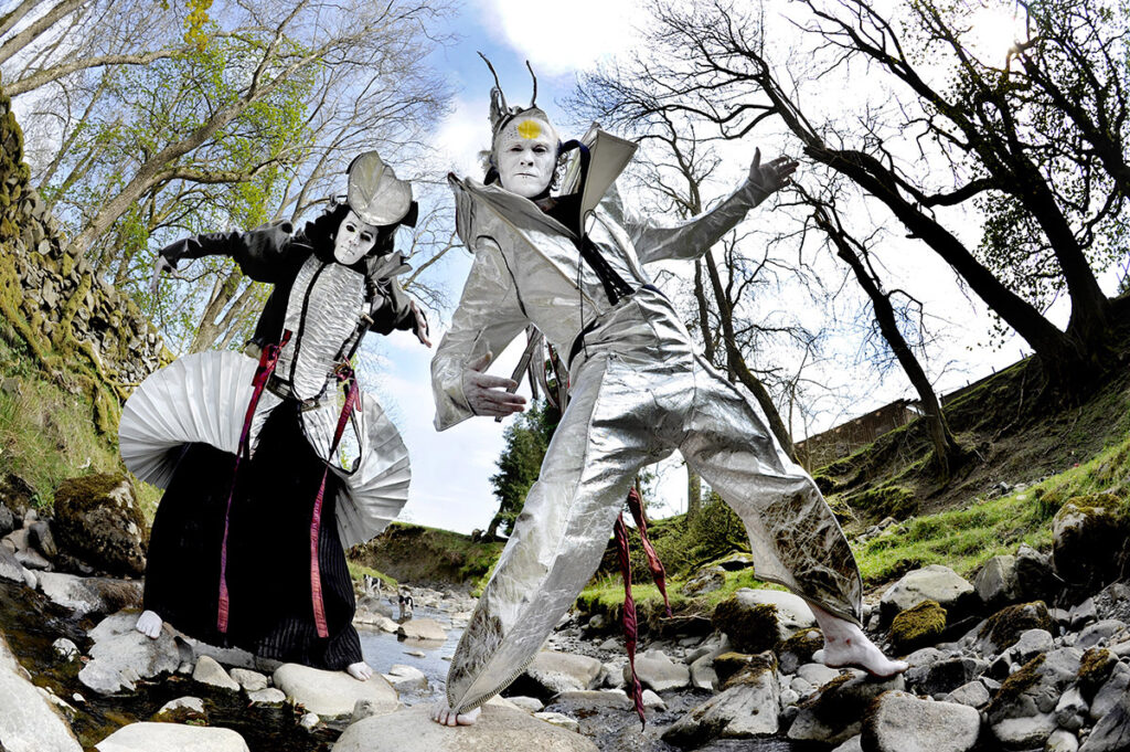 Costume designers and performance artists Alex Rigg and Florencia García Chafuén pictured in a river near their home in Moniaive, Dumfriesshire