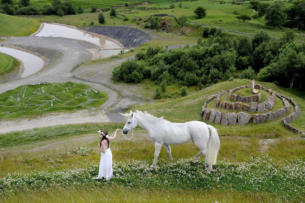 Charlie the unicorn at a solstice festival at Crawick Multiverse, Dumfriesshire - a landscape installation designed by Charles Jencks